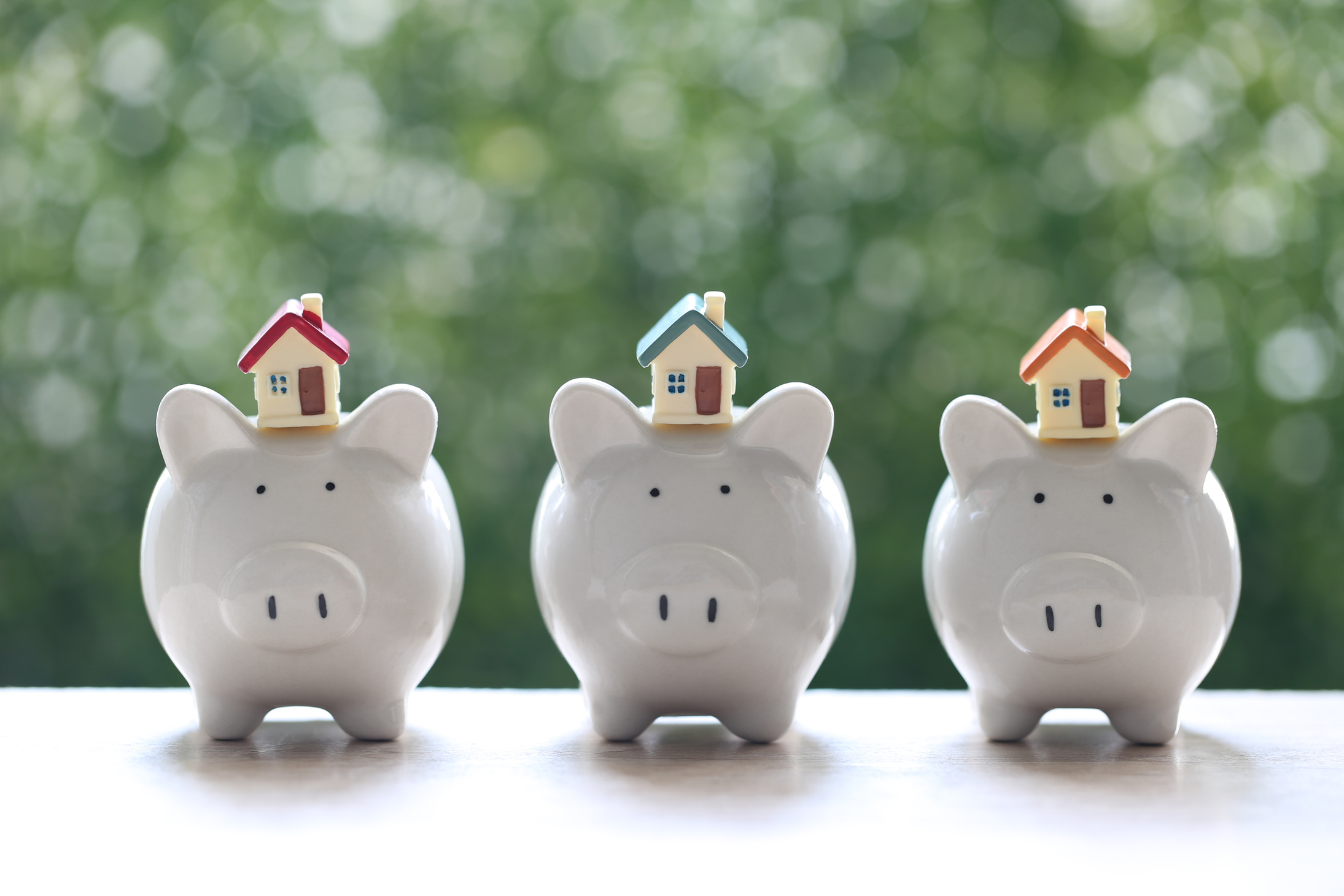 Model House on Piggy Bank with Stack of Coins 